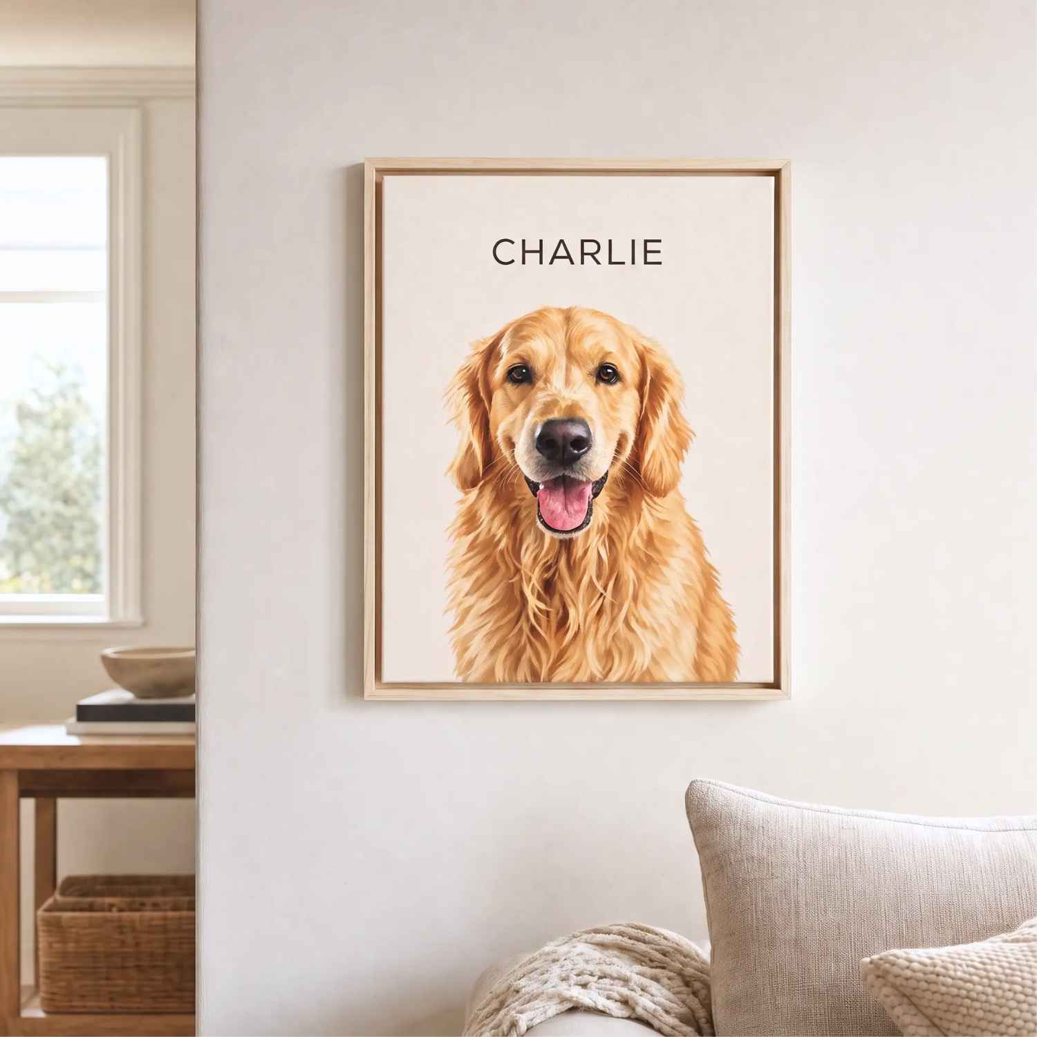 Framed custom pet portrait of Charlie the golden retriever on a cream background, natural frame, beside a sofa