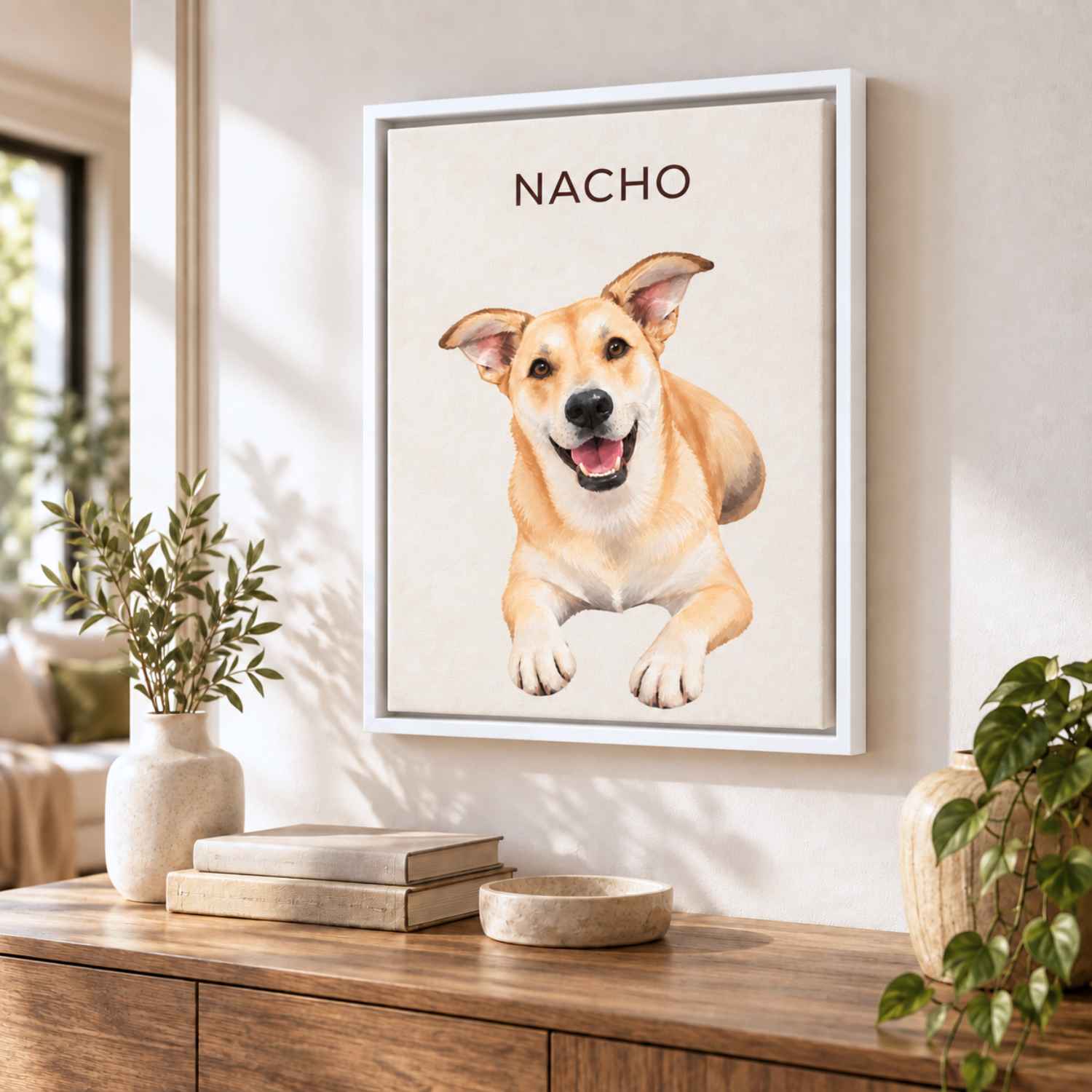 Nacho's custom pet portrait in a white frame on a sunlit wall above a wooden sideboard
