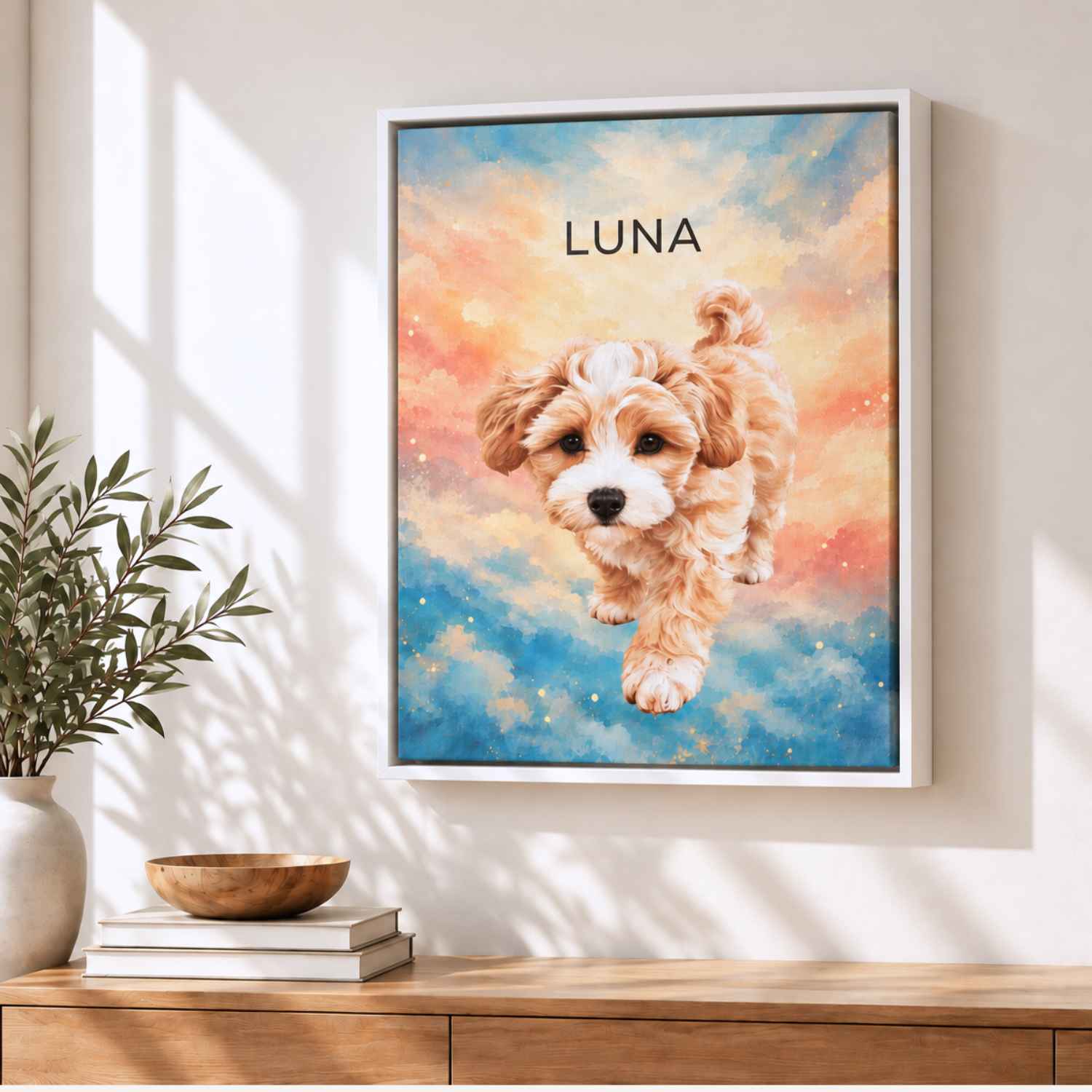 Framed custom pet portrait canvas of Luna the puppy on a sky-colored design, white frame, on a wooden sideboard